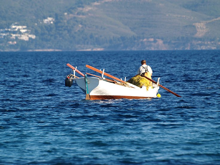 A greek fishing on a traditional boat